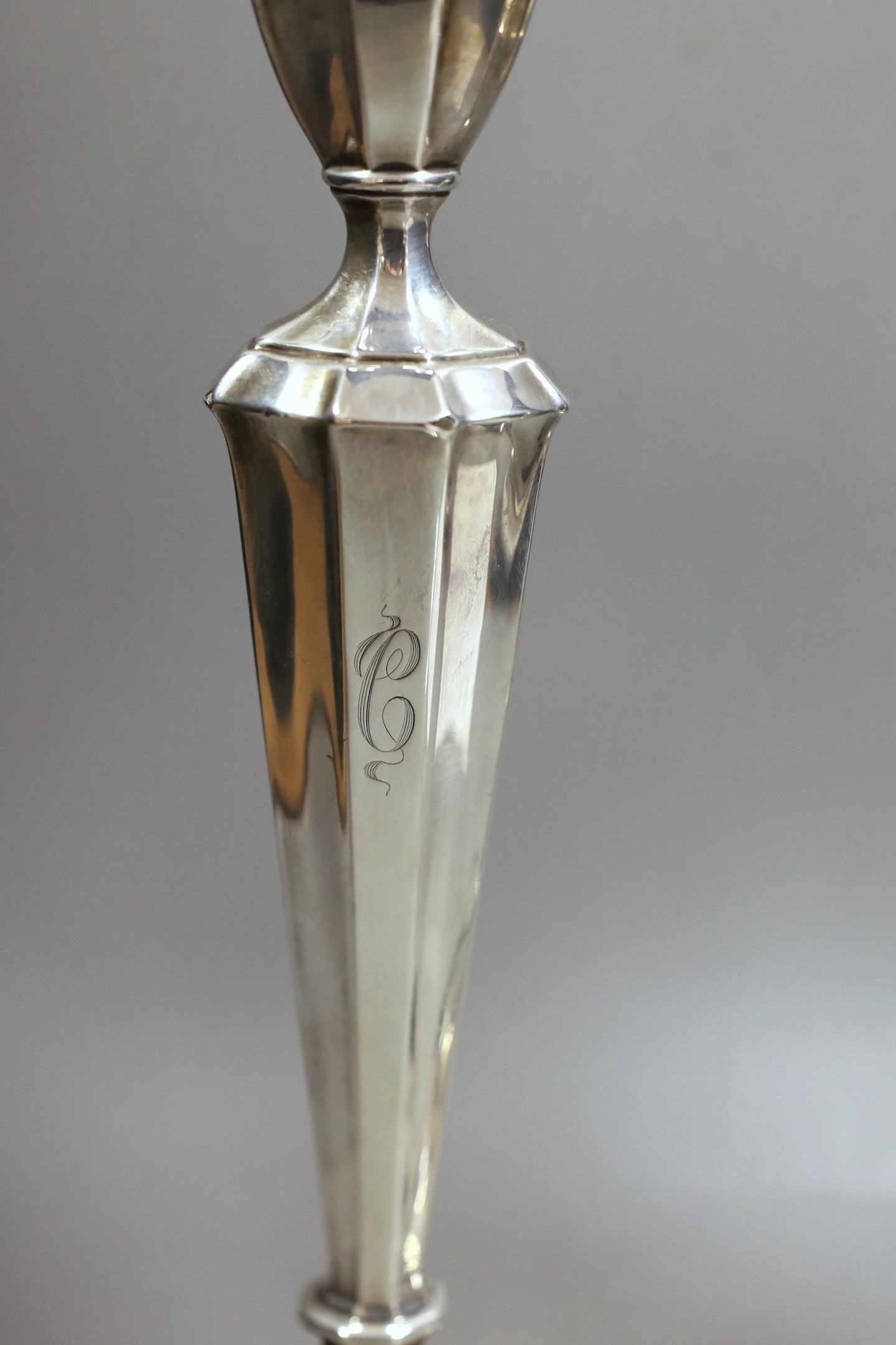 A pair of North American sterling candlesticks, with panelled stems and shaped oval bases, 34.1cm, weighted.